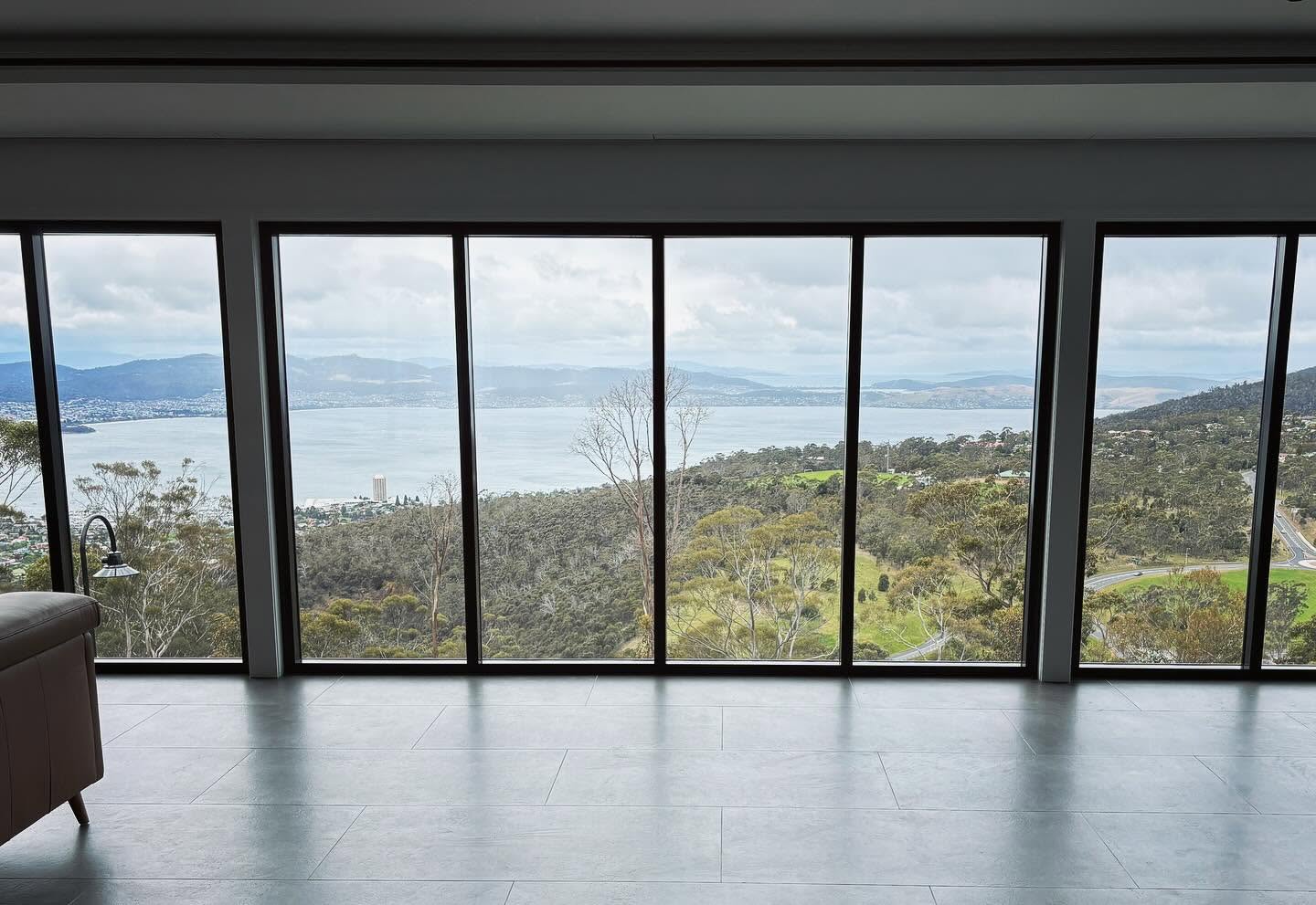 Floor-to-ceiling interior windows with a Hobart water view